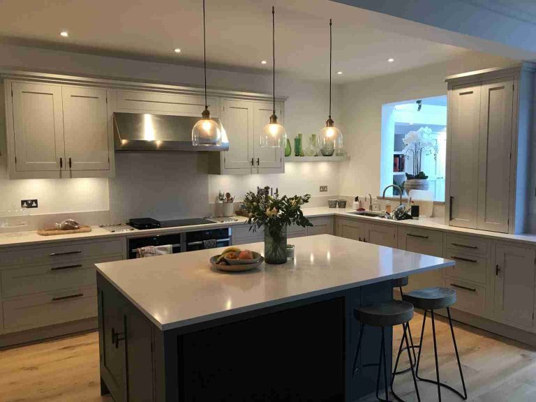 Kitchen island with bar stools and pendant lights photographed during a July 2021 project update