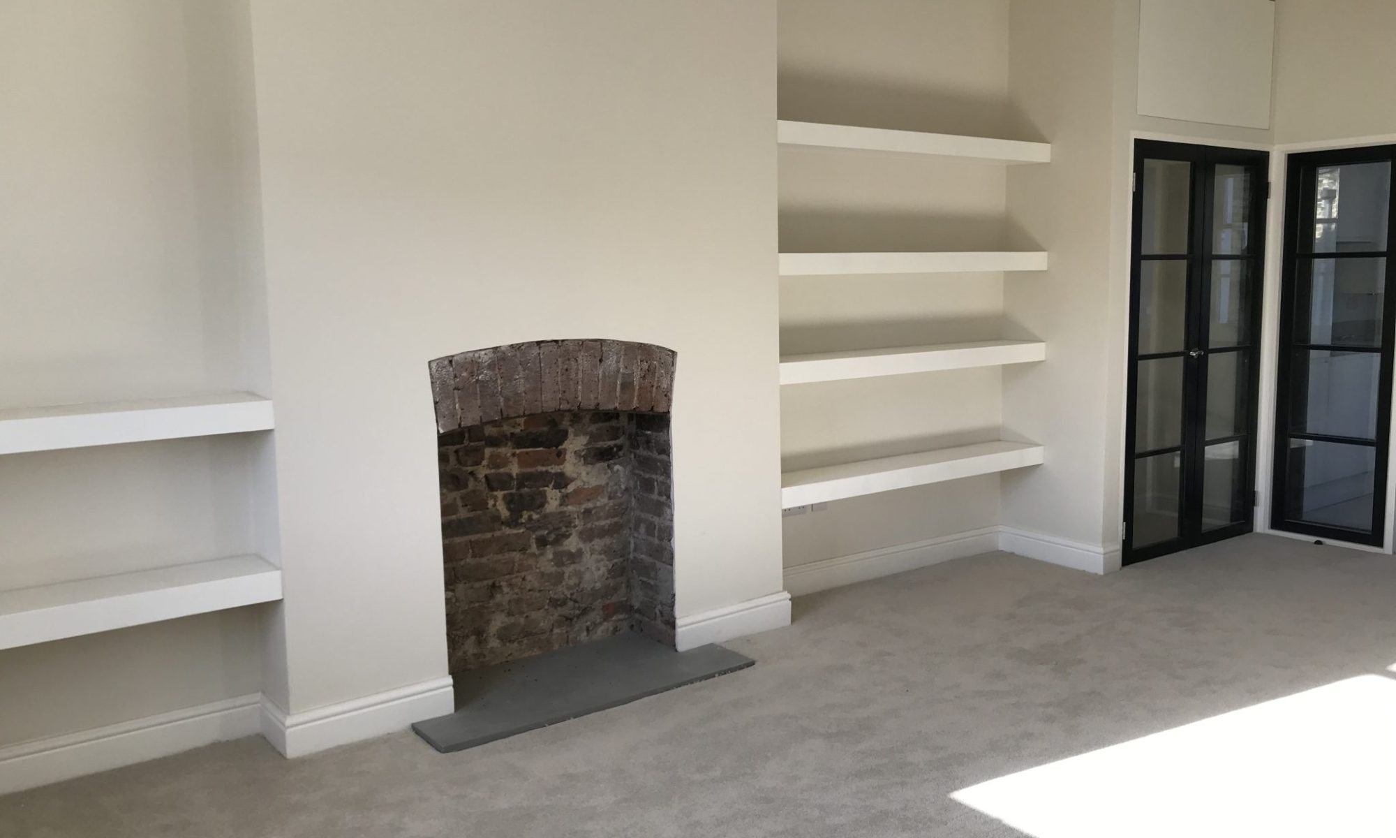 empty fireplace with wall racks 2