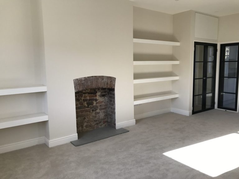 empty fireplace with wall racks 2