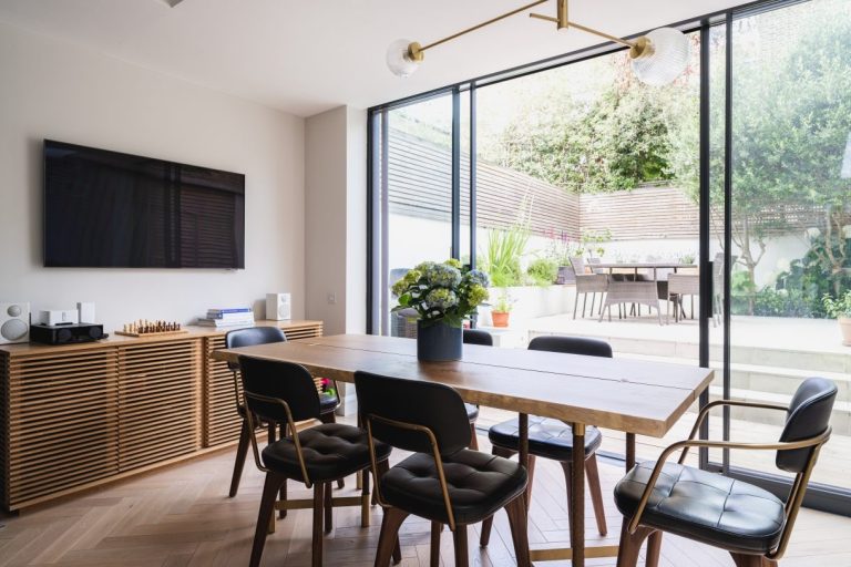 Open-plan kitchen and dining room with Crittall doors onto the garden in an eco-friendly renovation