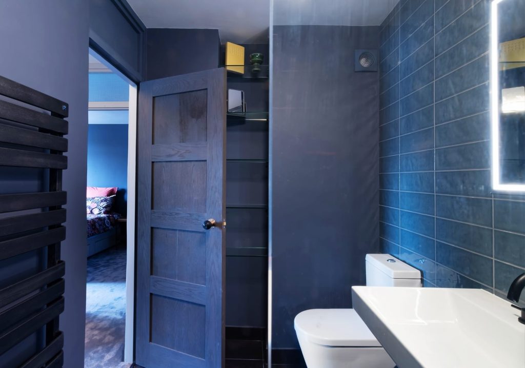 Blue tiled bathroom with wall-hung basin and walk-in shower, bathroom renovation in Fulham